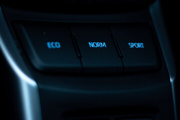 A picture showing eco mode, normal mode and sport mode keys in a car