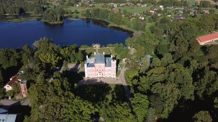 Wall Mural - Aerial View of the Birinu Palace. Latvian Castle by Lake With Nice Garden, Drone Shot. Birini Manor, Vidzeme Region, Latvia. Sunny Autumn Day