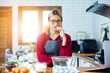 © vacancylizm - Beautiful young woman  is mixing batter, looking at camera and smiling while baking in kitchen at home ,decorating a cake of chocolate cake,cooking class, culinary, bakery, food and people concept
