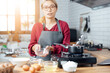 © vacancylizm - Beautiful young woman  is mixing batter, looking at camera and smiling while baking in kitchen at home ,decorating a cake of chocolate cake,cooking class, culinary, bakery, food and people concept