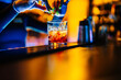 woman bartender making cocktail on bar in nightclub
