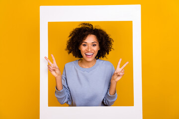Wall Mural - Portrait of attractive funky person toothy smile hands fingers demonstrate v-sign isolated on yellow color background