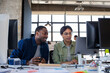 © ReeldealHD images - Coworkers working together at a desktop computer