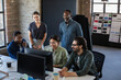 © ReeldealHD images - Group of coworkers meeting round a desktop computer