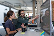 © ReeldealHD images - Coworkers looking at a desktop computer together