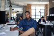 © ReeldealHD images - Portrait of African American businessman sitting at desk in an office