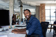 © ReeldealHD images - Portrait of African American businessman sitting at desk in an office