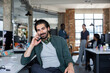 © ReeldealHD images - Portrait of businessman sitting at desk in an office