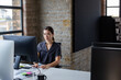 © ReeldealHD images - Young businesswoman working at a desktop computer in an office