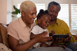 © ReeldealHD images - African American family watching entertainment on digital tablet at home