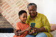 © ReeldealHD images - Grandson showing Grandmother how to use a smartphone
