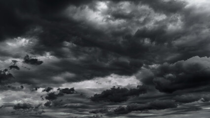 Wall Mural - dark dramatic sky with black stormy clouds before rain or snow as abstract background, extreme weath