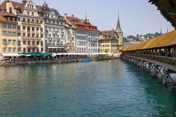 Wall Mural - LUCERNE, SWITZERLAND, JUNE 21, 2022 - View of the wodden covered Kapellbrucke Bridge on the Reuss river and buildings in city center of Lucerne, Switzerland