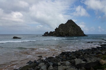 Poster - Meio beach in Brazil with a rocky shore on a bright sunny day