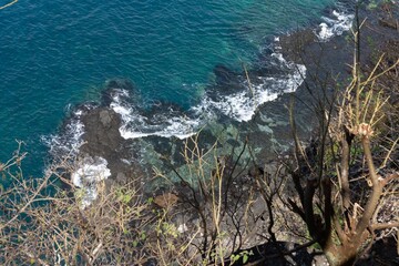 Poster - Rocky coast of the Baia dos Golfinhos beach in Brazil on a bright sunny day