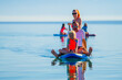 Happy Family on SUP stand up paddle on vacation.