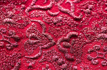 red and pink fabric texture background with embroided pattern