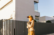 © VISTA by Westend61 - Freelancer wearing bird mask standing with tablet PC in front of building