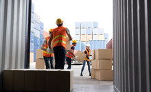 Men Worker Loading Cardboard Boxes Into Containers, Warehousing And Logistic Shipping Cargo Concept