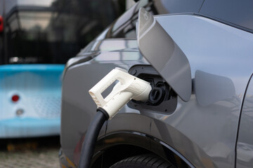 Wall Mural - electric car charging in the station