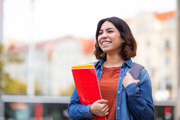 Portrait Of Happy Young Arab Student Woman Standing Outdoors