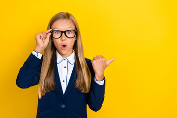 Canvas Print - Photo of astonished speechless staring girl arm direct demonstrate empty space big sales shopping isolated on yellow color background