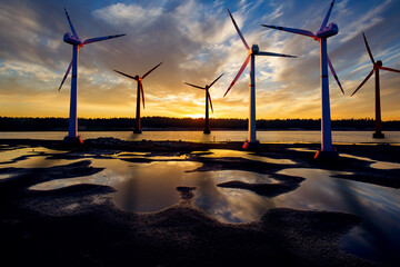 Windmills in water. Wind farm next to river. Windmills before sunset. Green energy. Windmills in evening sky. Green methods for generating electricity. Offshore wind generators. Clean energy