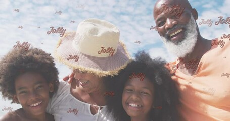 Sticker - Animation of jolly text and happy diverse grandchildren and grandparents on sunny beach at christmas