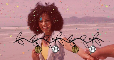 Wall Mural - Animation of christmas confetti and decorations over happy biracial woman laughing on sunny beach