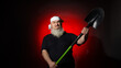 aggressive man with a beard brandishing a shovel on a red background