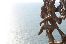 Statuette Of A Dancing Bronze Shiva Against The Background Of The Sea. Room For Text.