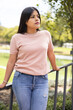 © Alejandro - young model with long straight hair wear basic t-shirt and jeans, latin woman beauty, having fun in the park with nature