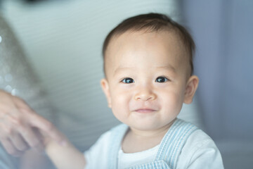 little cute child baby are happy and smile with mother and father at home in family together concept, young childhood having fun laughing and joy to play with parent in a room house lifestyle