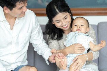 little cute child baby are happy and smile with mother and father at home in family together concept, young childhood having fun laughing and joy to play with parent in a room house lifestyle