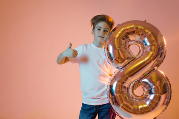 Boy with a balloon in the form of the number eight