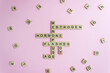 Word Menopause, Esrogen, Hormone, Age and Hot Flashes on wooden blocks on pink background. Women's health periods concept.