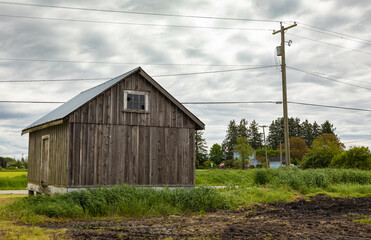 Old wooden farmhouse, vintage rural shed for storage in the countryside in Canada