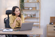 © David - Image of young indian pleased happy cheerful cute beautiful business Asian woman sit indoors in home office using laptop computer talking in a video conference on line