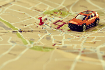 travel concept - small toy car on the map