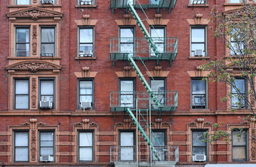 Wall Mural - Old fashioned New York apartment building .with ornate window frames and exterior fire escape