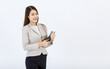 © Bangkok Click Studio - Isolated cutout studio shot of Millennial Asian professional successful happy businesswoman model in formal suit holding tablet computer posing standing smiling on white background.
