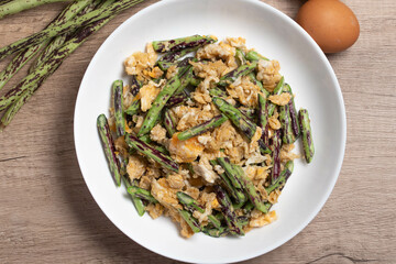 Wall Mural - Stir fried Yardlong bean with eggs on wooden background