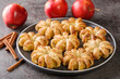 baked apples wrapped in puff pastry and sprinkled with sugar and cinnamon close-up in a plate on the table. horizontal