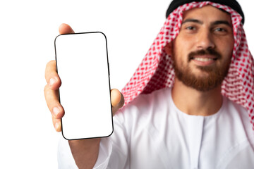Wall Mural - Young Arab muslim man in traditional clothes showing mobile phone isolated on a white background