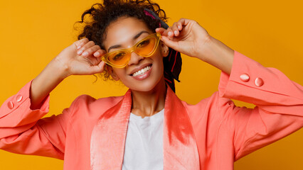 Laughing African woman over yellow background. True emotions, surprise face. Trendy look.