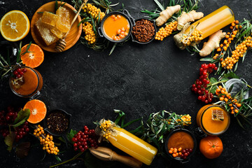 Autumn food concept: berries, honey, citrus fruits. Foods with a high content of vitamin C. On a dark background. top view