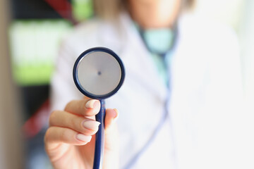 Sticker - Female doctor holds stethoscope in hands closeup