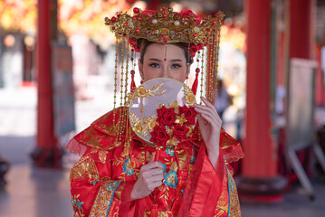 Portrait asian woman wearing traditional Chinese dress cheongsam for Chinese New Year