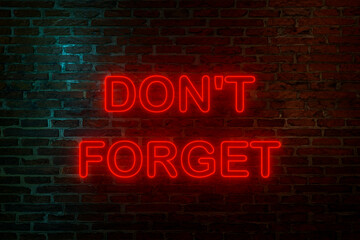 Don't forget, neon sign. Brick wall at night with the text 