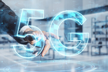 Poster - Close up of businessman hand pointing at abstract glowing 5G hologram on blurry office interior background. Mobile internet speed, communication and technology concept. Double exposure.